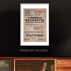 May include: A black and white poster with the text "To March on Washington, Wednesday August 28, 1963" and "March on Washington for Jobs and Freedom". The poster lists the names of several civil rights leaders, including Martin Luther King Jr., James Farmer, John Lewis, and A. Philip Randolph.