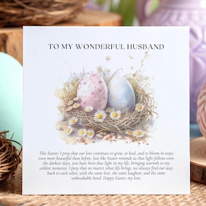 May include: Easter greeting card with the text "TO MY WONDERFUL HUSBAND". The card features a watercolor illustration of two decorated Easter eggs in a nest with daisies. The card is on a burlap surface with other Easter decorations.