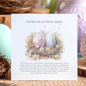 May include: A greeting card with the text "TO MY BEAUTIFUL WIFE" and a watercolor illustration of two decorated Easter eggs in a nest with daisies. The card is on a wooden surface with Easter eggs and decorative vases in the background.