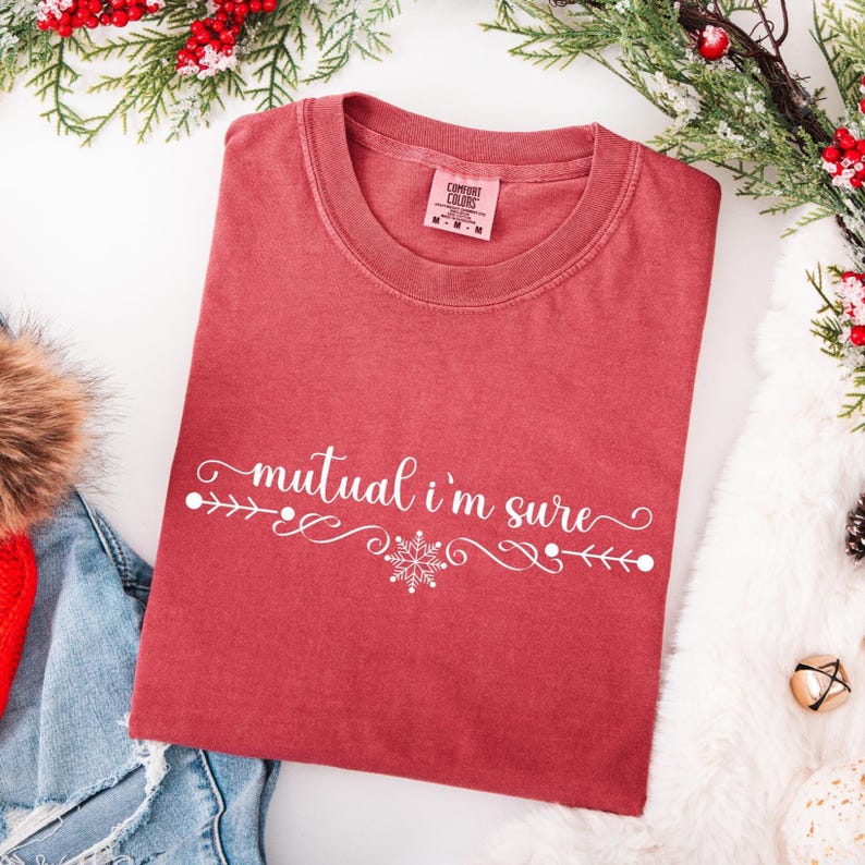 Crimson Comfort Colors unisex tshirt with a text based design in cursive white lettering it says - Mutual I'm Sure.  Underneath there is a snowflake in center of a flourished line.  Mutual I'm Sure statement shirt, Classic movie shirt, movie quote t-shirt, mutual i'm sure tshirt, Trendy holiday tee.