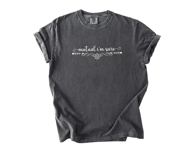 Puede incluir: Una camiseta de manga corta en color gris carb&oacute;n con el texto blanco "mutual i'm sure" impreso en el pecho. El texto est&aacute; centrado y flanqueado por adornos blancos decorativos y un peque&ntilde;o icono en forma de estrella, creando un dise&ntilde;o equilibrado.