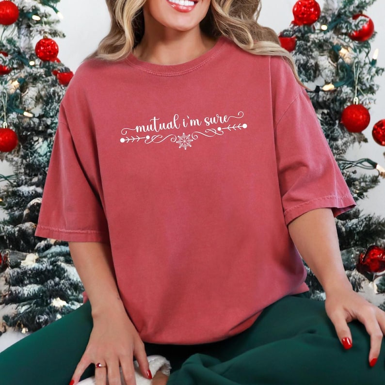 Crimson Comfort Colors unisex tshirt with a text based design in cursive white lettering it says - Mutual I'm Sure.  Underneath there is a snowflake in center of a flourished line.  Mutual I'm Sure statement shirt, Classic movie shirt, movie quote t-shirt, mutual i'm sure tshirt, Trendy holiday tee.