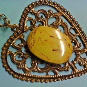 Pendant necklace with genuine tested vintage 1950s flamy swirled olive green tested bakelite plastic cabochon and antiquecolor bronze heart