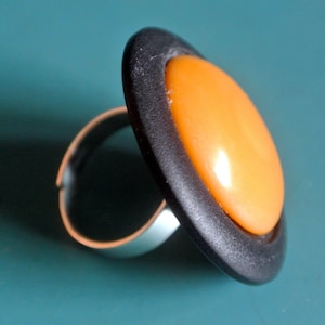 Large amazing adjustable silvercolor metal ring with black plastic and genuine tested vintage 1950s opaque buttschotch yellow bakelite bead