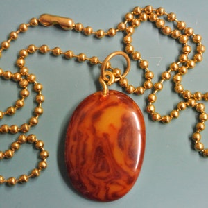 Pendant necklace with genuine tested vintage 1950s flamy swirled dark brown/ butterschotch yellow bakelite plastic bead and brass ball chain