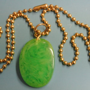Pendant necklace with genuine tested vintage 1950s flamy swirled light grass green bakelite plastic bead and brass ball chain