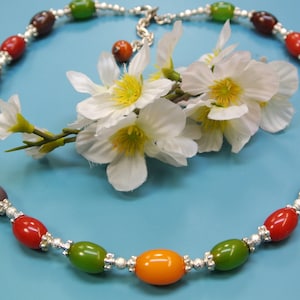 Unique one-of-a-kind adjustable multicolor necklace made of oval genuine tested vintage 1940s bakelite beads, lobster clasp and beadcaps