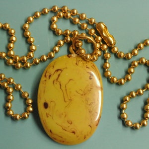 Pendant necklace with opaque genuine tested vintage 1950s flamy swirled olive green bakelite plastic bead and brass ball chain