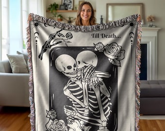 May include: Black and white woven throw blanket with a graphic of two skeletons embracing. The skeletons are in a heart shape and the text "Till Death..." is above them.