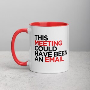 May include: White ceramic mug with a red rim and handle. The mug has black text that reads "This Meeting Could Have Been An Email."