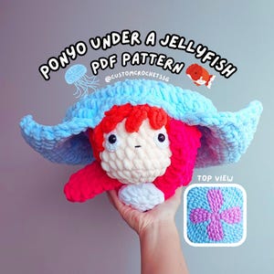 May include: Crochet pattern for a plush toy of Ponyo from the movie Ponyo, under a blue jellyfish. The pattern is called "Ponyo Under a Jellyfish PDF Pattern" and includes a top view of the finished product. The pattern is available on Etsy from the shop @customcrochetssg.