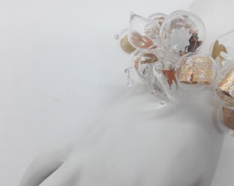 Clear blown glass bubble bracelet with metallic confetti and metal foil scrolls