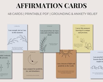 May include: A collection of affirmation cards with various designs and affirmations. The cards are in different colors, including blue, green, and tan, with minimalist illustrations of plants, sun, moon, and butterflies. The text on the cards promotes grounding and anxiety relief.