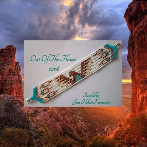 May include: A white beaded bracelet with a brown eagle design and turquoise accents. The bracelet is on a white card with the text "Out Of The Flames 2014" and "Beaded by Jan Hebert Parmenter".