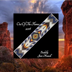 May include: A beaded bracelet with a geometric pattern in shades of blue, white, yellow, and orange. The bracelet is titled "Out Of The Flames 2014" and is beaded by Joan Maxwell.