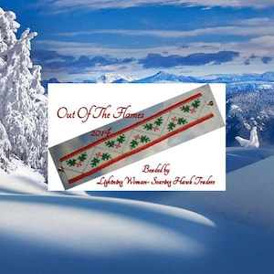 May include: A white and green beaded bracelet with red and gold accents. The bracelet has a pattern of holly leaves and berries. The text "Out Of The Flames 2014" and "Beaded by Lightning Woman - Soaring Hawk Traders" is visible on the image.