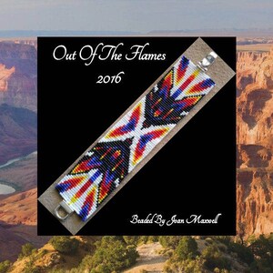 May include: A beaded bracelet with a geometric pattern in red, white, blue, black, and yellow. The bracelet is titled "Out Of The Flames 2016" and is beaded by Joan Maxwell.