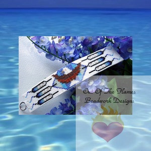 May include: A white beaded bracelet with a blue, white, and red design. The bracelet features a stylized image of a bird with feathers. The text "Out Of The Flames Beadwork Designs" is visible in the image.