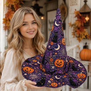 May include: A quilted witch hat in a deep purple fabric featuring a repeating pattern of black cats, orange jack-o'-lanterns, white spiderwebs, crescent moons, and small purple and orange flowers across the pointed crown and wide brim.