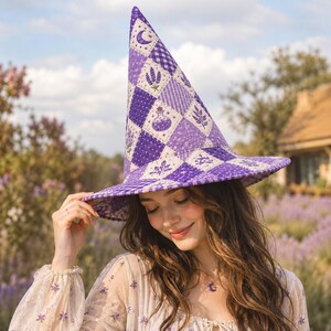 May include: A tall, pointed hat featuring a quilted diamond pattern in various shades of purple and white. The fabric displays printed motifs including crescent moons, lavender sprigs, and small potion bottles, with a wide, structured brim.