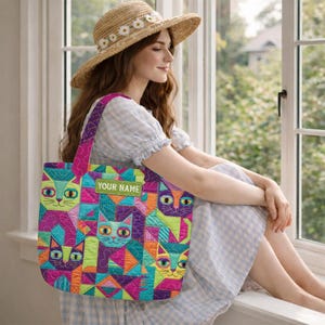 May include: A quilted tote bag featuring a vibrant geometric pattern of stylized cats in shades of lime green, magenta, orange, and teal. The bag includes a rectangular green patch with the white text YOUR NAME centered on the front surface.