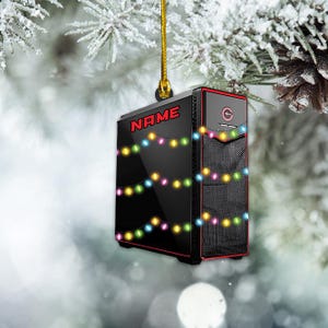 May include: A black computer tower with a red trim and a white nameplate that says "NAME". The tower is decorated with colorful Christmas lights.