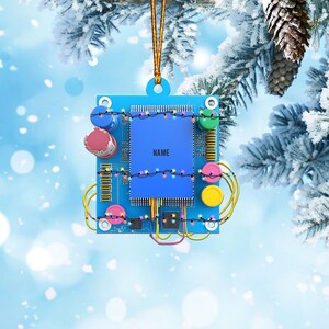 May include: A blue circuit board Christmas ornament with colorful lights and the word "NAME" on the chip.