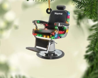 Könnte beinhalten: Ein schwarzer Friseurstuhl-Weihnachtsbaumschmuck mit Chromfuß und bunten Lichtern. Der Stuhl hat eine Kopfstütze mit dem Wort "Name" darauf.