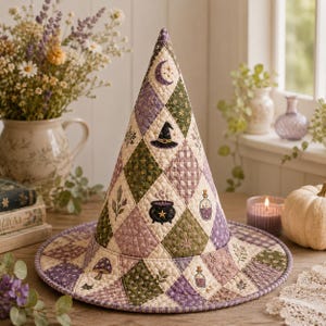 May include: A quilted witch hat featuring a diamond-patterned patchwork design in shades of purple, green, and cream. The fabric is decorated with embroidered motifs including a crescent moon, a black hat, a cauldron, potion bottles, and mushrooms.
