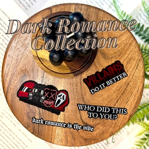 May include: A wooden tray with a small wooden plate holding black bubble candles. The tray also displays stickers with text: "Dark Romance Collection", "Villains Do It Better", "Who Did This To You?", and "Masked Men Do It Best".