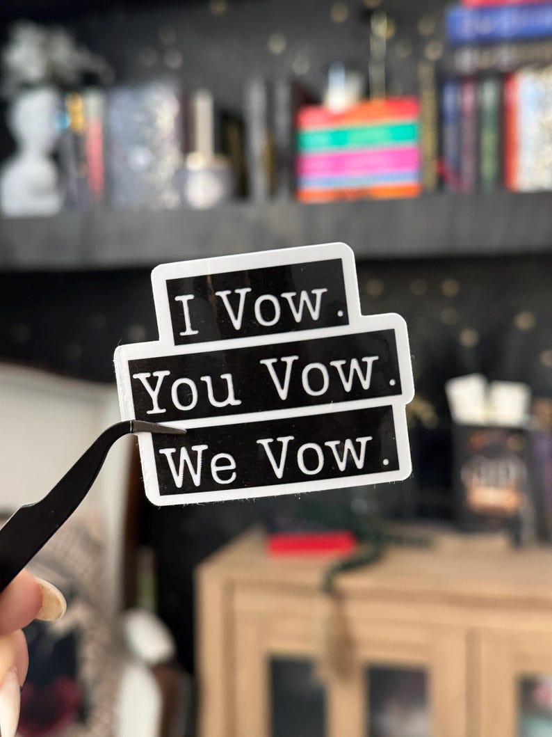 May include: Black and white sticker with the text "I Vow. You Vow. We Vow."
