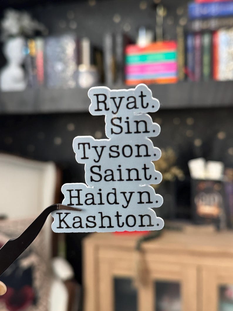 May include: A white sticker with black text listing the names Ryat, Sin, Tyson, Saint, Haidyn, and Kashton.