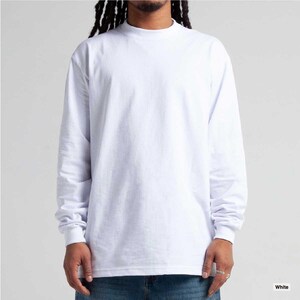 May include: A long-sleeved, white mock neck shirt. The shirt has a high neckline and long sleeves that extend to the wrists. The fabric appears to be a soft, opaque material. The shirt is a solid white color.