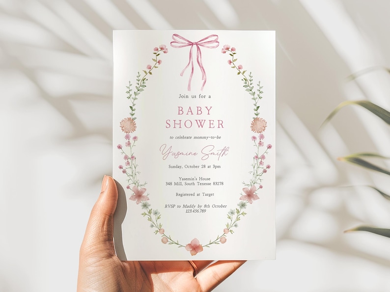 Looking for a sophisticated Pink Bow Baby Shower Invitation Template? This editable coquette girl baby shower invite features a dusty blush pink ribbon and minimalist hand-drawn floral accents. Perfect for a French Chinoiserie or Toile themed sprinkle. This high-quality digital download is easy to customize for a timeless, elegant baby girl celebration. Buy now for a printable or mobile-friendly invitation that fits the trendy coquette aesthetic and minimalist wildflower style.