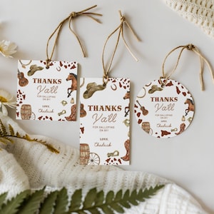 May include: Three western-themed gift tags with brown twine. The tags feature cowboy hats, horses, boots, and the text "Thanks Y'all". One tag is square, one is rectangular, and one is circular, all with a rustic design.