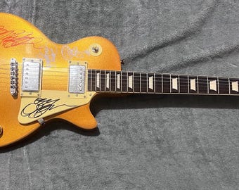 Les Paul type electric guitar signed by the band Ozzy Osbourne Tony Iommi Black Sabbath
