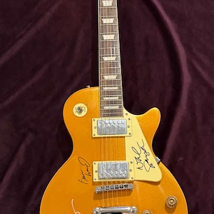 Les Paul style electric guitar signed by the band Oasis