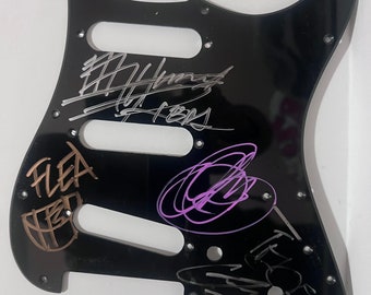 Electric guitar pickguard autographed by Anthony K. Chad S. John F.