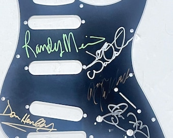 Guitar pickguard signed by the Eagles band