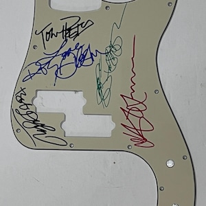 Electric guitar pickguard signed by Traveling Wilburys Roy Orbison Jeff Lynne Bob Dylan Tom Petty George Harrison