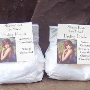 May include: Two clear plastic bags filled with white dusting powder. Each bag has a label with the text "Allegheny Hearth Pure Natural Dusting Powder" and a vintage illustration of a woman. One label lists "Arrowroot, Cornstarch, Natural Unscented". The other lists "Arrowroot, Cornstarch, Aloe Vera, Vit E. Lavender & Chamomile Essential Oils".