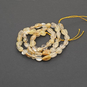 Rutilated quartz chips beads, 15" strand clear and reddish with gold and black threads semiprecious stone