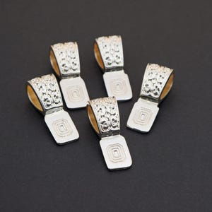 May include: A set of three ceramic mugs with a speckled, matte finish. The mugs are in shades of cream, light gray, and dark gray. Each mug has a simple, minimalist design, perfect for coffee or tea.