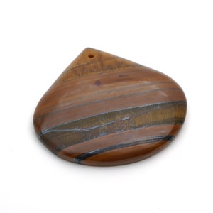 May include: A teardrop-shaped pendant made of tiger's eye stone. The stone has a brown, gold, and black color with a striated pattern.