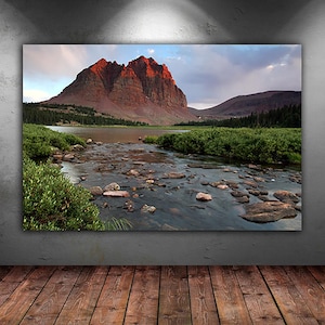 a serene landscape with a river flowing through a mountainous terrain, surrounded by lush greenery and rocky banks.