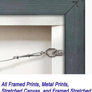 A metal frame is attached to a stretched canvas, ready to hang out of the box.
