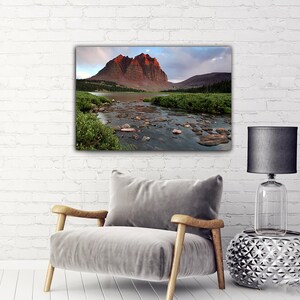 a serene landscape with a mountain range in the background and a river flowing through the foreground.