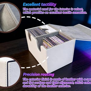May include: A white leather card storage box with a gray velvet interior and a hinged lid. The box has a smooth, flat surface and tight alignment. The text in the image says "Excellent tactility" and "Precision routing".
