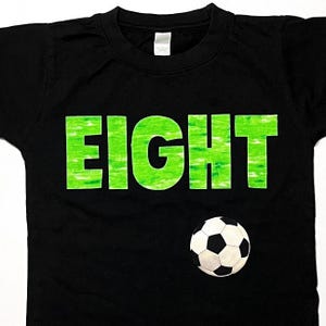 Boys Soccer Birthday Shirt, Eight Year Old, green grass lettering, soccer ball, game day, black short sleeve, custom number and size