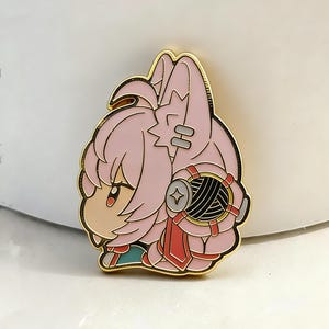 Könnte beinhalten: Ein pinkfarbener Emaille-Pin mit einem Cartoon-Charakter mit rosa Haaren und goldenen Konturen. Der Charakter hat einen entschlossenen Gesichtsausdruck und trägt ein rotes Band und ein schwarz-silbernes Accessoire. Ein Sammler-Pin.